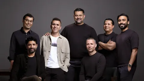 Excel Entertainment founders and Universal Music executives, seven men in dark clothes, posing at the Excel Music launch