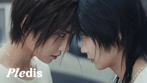 Jeonghan and Joshua of SEVENTEEN, forehead to forehead in close-up, from the JxJ 12 o'clock music video